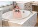 Oval drop-in bathtub with a modern faucet and pink towel accents at 12840 W Santa Ynez Dr, Sun City West, AZ 85375