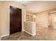 Entryway with a dark wooden door, tile flooring, and a view into the living area at 12840 W Santa Ynez Dr, Sun City West, AZ 85375
