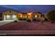 One story home with a two car garage at dusk at 12840 W Santa Ynez Dr, Sun City West, AZ 85375