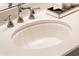 Close-up of an oval bathroom sink with subtle etched detailing at 12840 W Santa Ynez Dr, Sun City West, AZ 85375