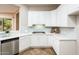 Modern kitchen with white cabinets, stainless steel appliances, and light blue backsplash at 12840 W Santa Ynez Dr, Sun City West, AZ 85375