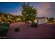 Landscaped backyard with mature trees at dusk at 12840 W Santa Ynez Dr, Sun City West, AZ 85375