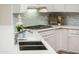 Modern kitchen with white cabinets and quartz counters at 12840 W Santa Ynez Dr, Sun City West, AZ 85375