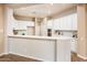 Bright kitchen with white cabinets and breakfast bar at 12840 W Santa Ynez Dr, Sun City West, AZ 85375