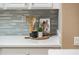 Stylish kitchen details, including wood utensils and decorative accents on quartz countertops at 12840 W Santa Ynez Dr, Sun City West, AZ 85375