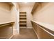 Spacious closet with custom shelving and hanging rods at 12840 W Santa Ynez Dr, Sun City West, AZ 85375