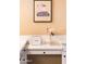 Stylish bathroom vanity with a quartz countertop, decorative elements, and framed art at 12840 W Santa Ynez Dr, Sun City West, AZ 85375