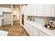 White kitchen cabinets and tile backsplash at 12840 W Santa Ynez Dr, Sun City West, AZ 85375
