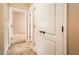 Bright hallway with tile flooring and white doors at 12840 W Santa Ynez Dr, Sun City West, AZ 85375