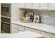 Modern kitchen features white cabinets, quartz countertops, and stainless steel appliances at 12840 W Santa Ynez Dr, Sun City West, AZ 85375