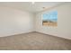 Bright bedroom with neutral carpeting and large window at 2644 E Rosario Mission Dr, Casa Grande, AZ 85194