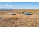 Aerial view of a property with a house, carport, and distant solar panels at 35203 W Indian School Rd, Tonopah, AZ 85354