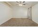 Bright bedroom featuring neutral carpeting and large windows at 35203 W Indian School Rd, Tonopah, AZ 85354