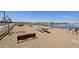 Relaxing pondside seating with picnic tables and benches at 2622 E Homesteader Rd, San Tan Valley, AZ 85140