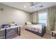 Bedroom with twin bed, desk, and wall decor at 40350 W Art Pl, Maricopa, AZ 85138