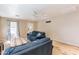 Cozy living room featuring two blue sofas and light wood floors at 40350 W Art Pl, Maricopa, AZ 85138