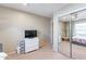 Bright bedroom with mirrored closet doors and a view of a bed at 40350 W Art Pl, Maricopa, AZ 85138