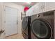 Laundry room with washer, dryer, and ample cabinet space at 40350 W Art Pl, Maricopa, AZ 85138