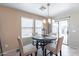 Bright dining area with table and chairs, and access to backyard at 40350 W Art Pl, Maricopa, AZ 85138