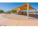Community playground with shaded play structure and seating at 40350 W Art Pl, Maricopa, AZ 85138