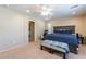 Spacious Primary bedroom with a king-size bed and ensuite bathroom access at 40350 W Art Pl, Maricopa, AZ 85138