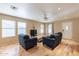 Living room with hardwood floors, two sofas, and a TV at 40350 W Art Pl, Maricopa, AZ 85138