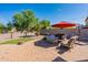 Spacious patio perfect for entertaining, with seating and fire pit at 40350 W Art Pl, Maricopa, AZ 85138