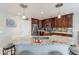 Modern kitchen with granite countertops and dark wood cabinets at 40350 W Art Pl, Maricopa, AZ 85138