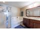 Bathroom with granite countertops, double sinks, and a shower at 40350 W Art Pl, Maricopa, AZ 85138