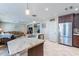 Granite kitchen island with stainless steel appliances and breakfast bar at 40350 W Art Pl, Maricopa, AZ 85138