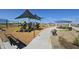 Modern playground with shade structures, play equipment, and benches at 2622 E Homesteader Rd, San Tan Valley, AZ 85140