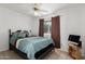 Bedroom with wood frame bed, ceiling fan, and window coverings at 4144 N 74Th Dr, Phoenix, AZ 85033