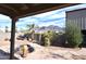 Landscaped backyard with a fire pit, palm trees, and mountain views at 423 S Arroya Rd, Apache Junction, AZ 85119