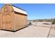 Wooden storage shed in the backyard at 23208 W Gloria Ln, Wittmann, AZ 85361