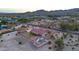 Aerial view of a house with a pool, a large yard, and mountain views at 20132 W Medlock Dr, Litchfield Park, AZ 85340