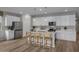 Modern kitchen with white cabinets, stainless steel appliances, and island at 3035 W Thurman Dr, Laveen, AZ 85339