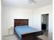Spacious bedroom with a dark wood bed frame and blue bedding at 2511 W Queen Creek Rd # 417, Chandler, AZ 85248