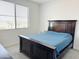 Bright bedroom with a dark wood bed frame and blue bedding at 2511 W Queen Creek Rd # 417, Chandler, AZ 85248