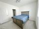 Cozy bedroom with gray bed frame and blue bedding at 2511 W Queen Creek Rd # 417, Chandler, AZ 85248