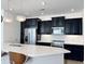 Modern kitchen with dark cabinets, white countertops, and island at 2511 W Queen Creek Rd # 417, Chandler, AZ 85248