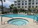 Community pool and spa with surrounding lounge chairs at 2511 W Queen Creek Rd # 417, Chandler, AZ 85248