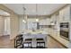 Modern kitchen with white cabinets, granite countertops, stainless steel appliances, and a curved island at 20815 W Canyon Dr, Buckeye, AZ 85396