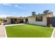 Large backyard, artificial turf, and a view of the home's exterior at 2520 E Flower St, Phoenix, AZ 85016