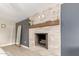 Modern fireplace with stone and wood mantel at 2520 E Flower St, Phoenix, AZ 85016