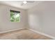 Spacious bedroom with a window offering natural light and carpet flooring at 2520 E Flower St, Phoenix, AZ 85016