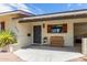 Front entrance with grey door, wood bench, and desert landscaping at 2520 E Flower St, Phoenix, AZ 85016