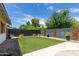Landscaped backyard with artificial turf and modern wall accents at 2520 E Flower St, Phoenix, AZ 85016