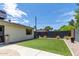 Landscaped backyard with artificial turf and modern wall accents at 2520 E Flower St, Phoenix, AZ 85016