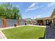 Spacious backyard with artificial turf and a modern wall at 2520 E Flower St, Phoenix, AZ 85016