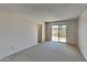 Bedroom with sliding door leading to a patio at 3013 W Hearn Rd, Phoenix, AZ 85053